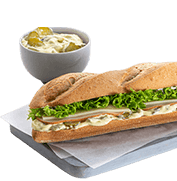 White baguette with turkey, edam and white sauce with pickled cucumber